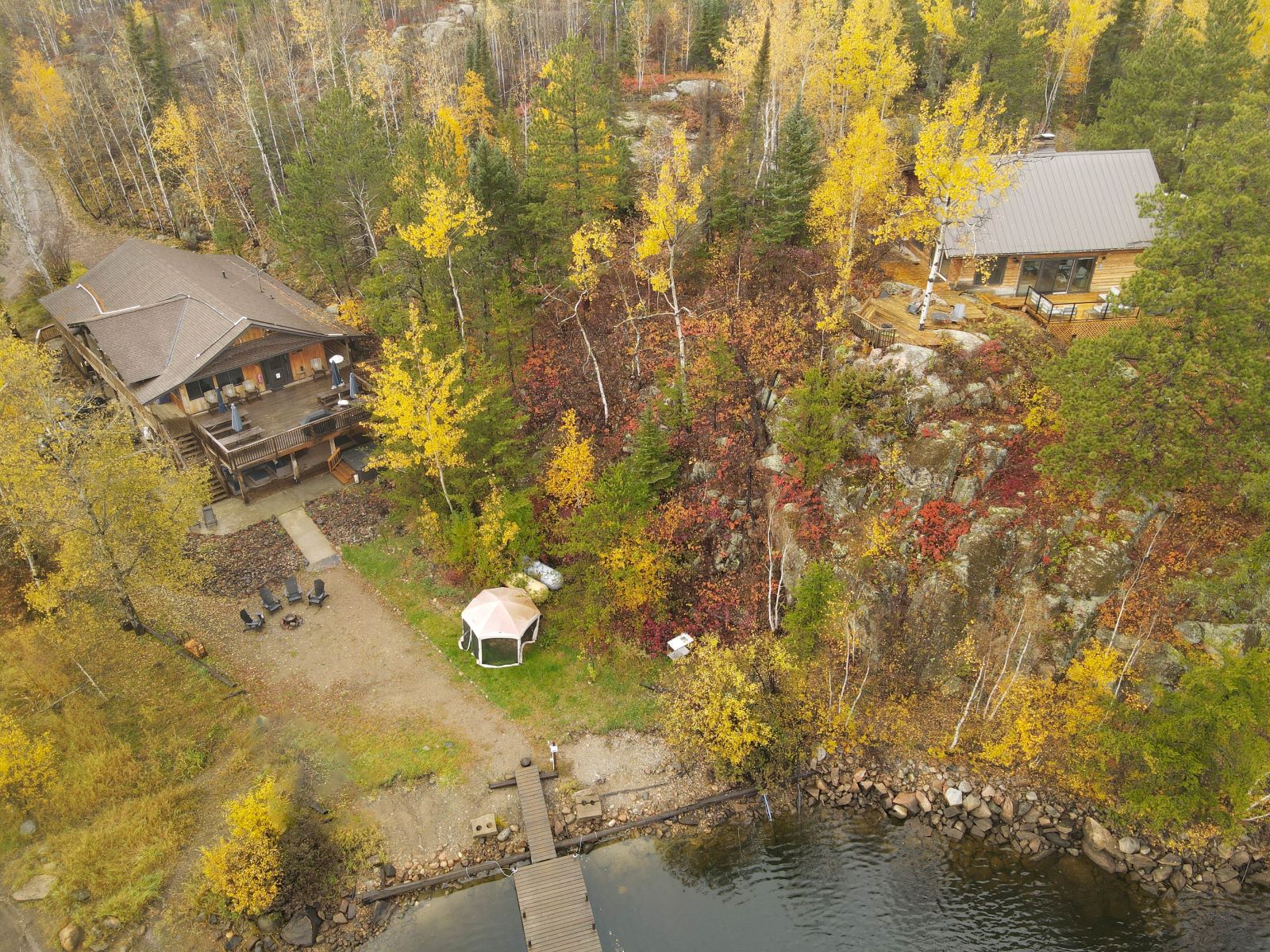 aerial view of the main lodge and cabin with fall colors